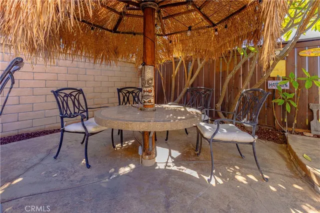 a view of a backyard with table and chairs and potted plants