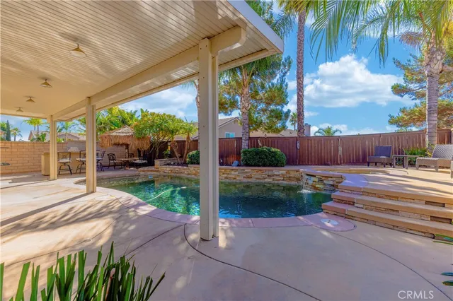 a view of a patio with table and chairs potted plants with wooden fence