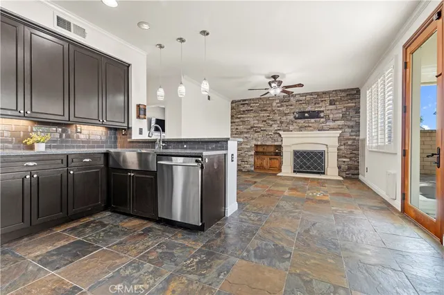 a kitchen with stainless steel appliances granite countertop a stove top oven sink and cabinets