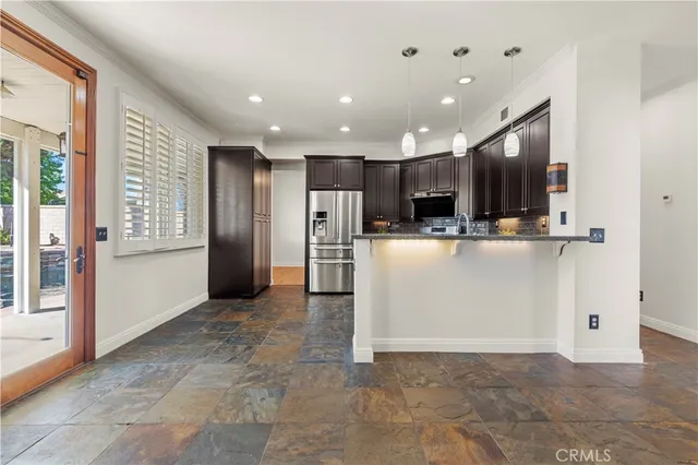 a view of a kitchen with refrigerator and a sink