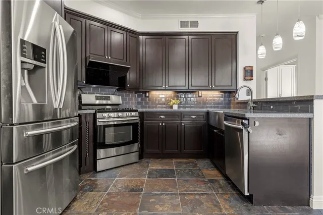 a kitchen with a stove sink and refrigerator