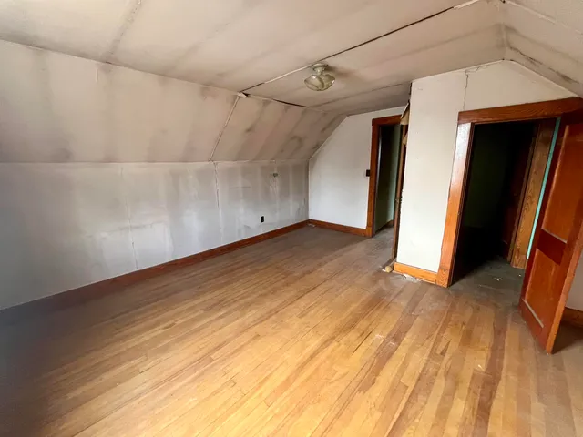 a view of a room with wooden floor