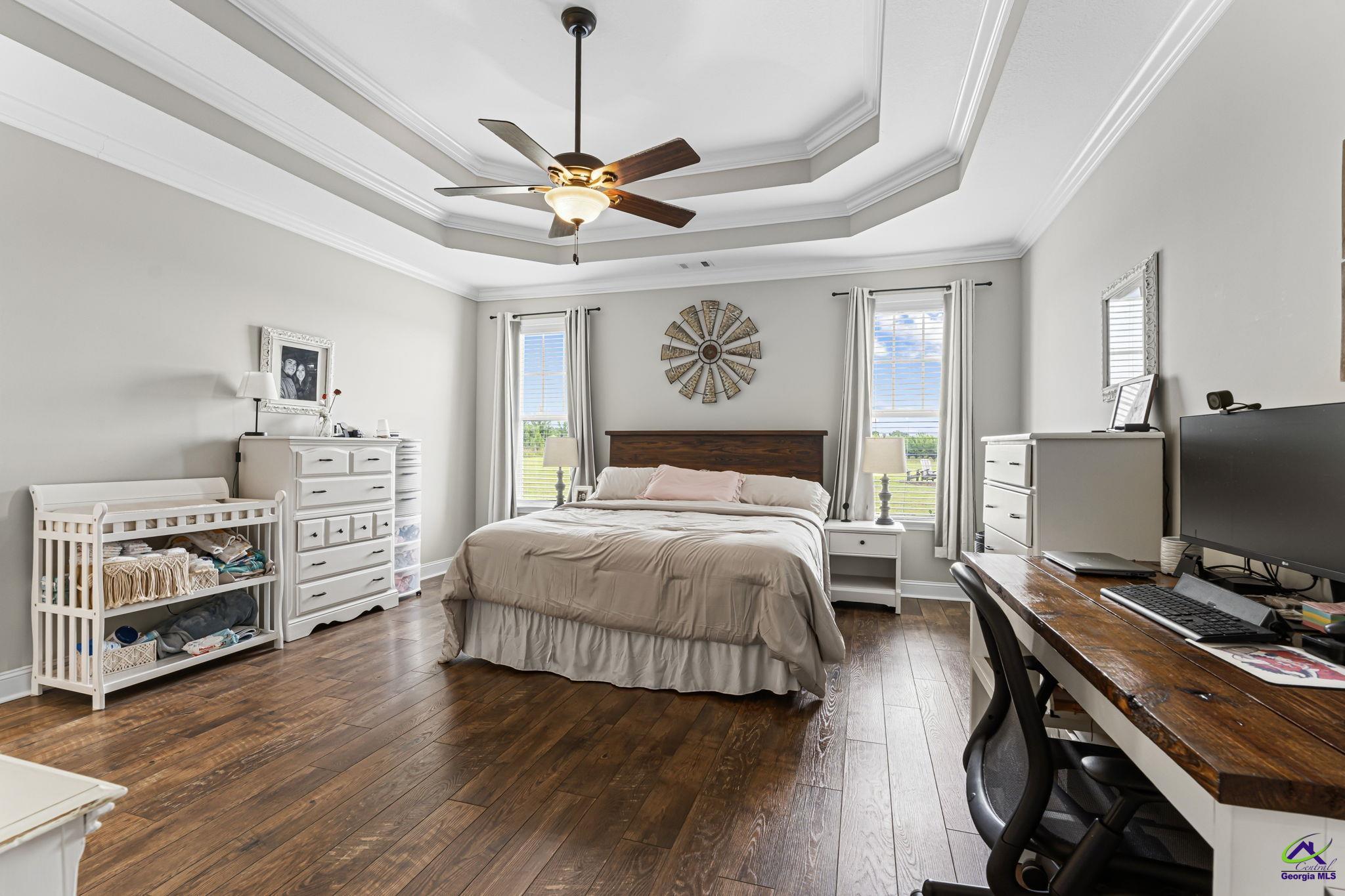 180 Woodland Trail Road Cochran, GA 31014 - Photo 13 of 25 a bedroom with a bed and a chandelier