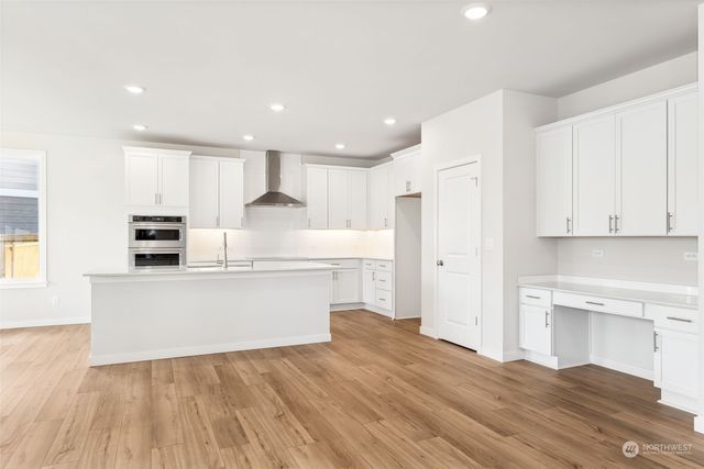 a view of an empty room with a kitchen