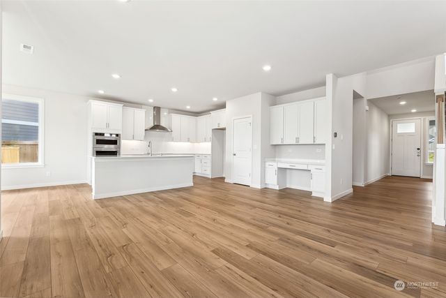 an open kitchen with granite countertop a stove and a sink with granite countertops