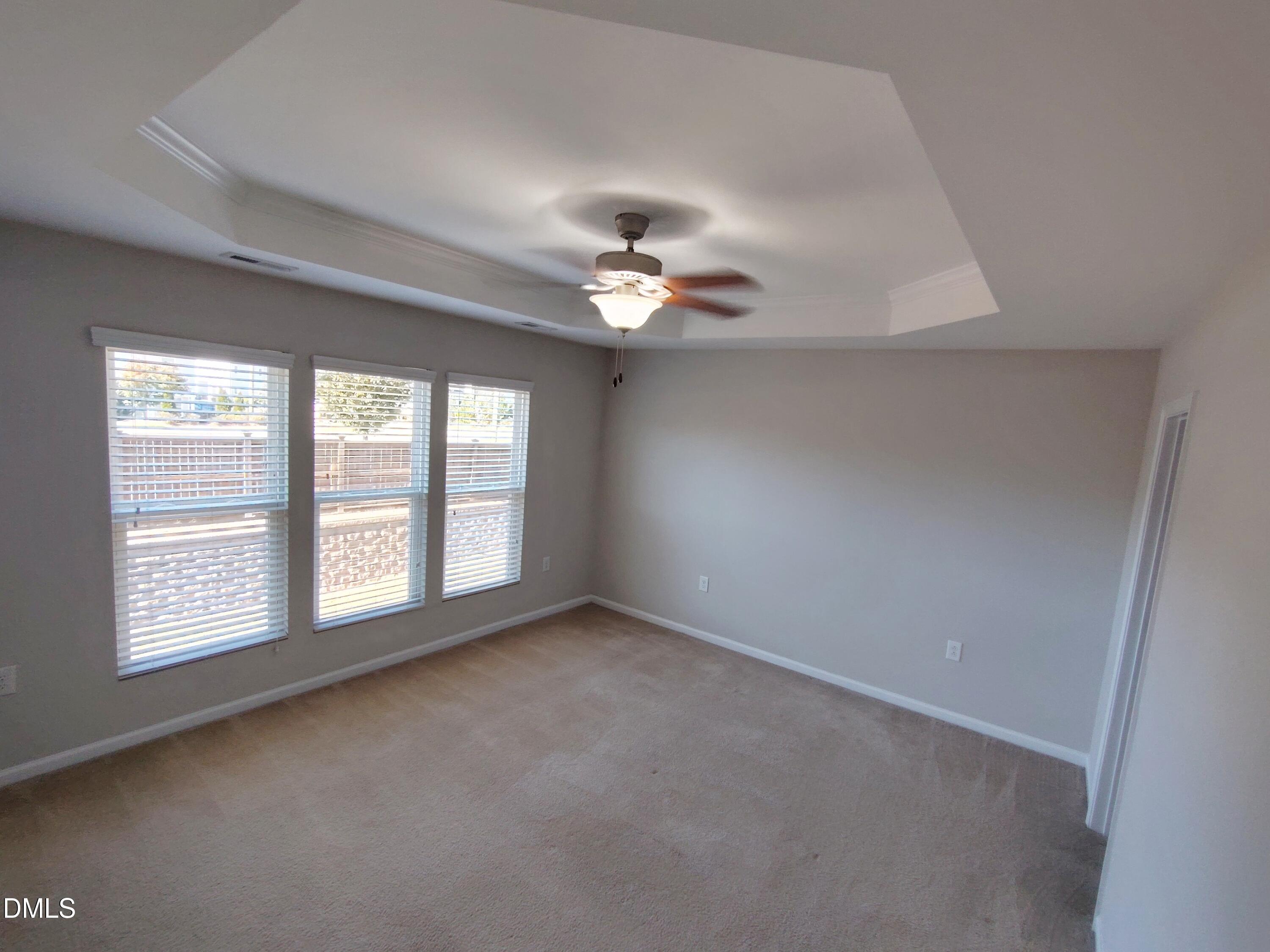 1013 Kudzu Street Durham, NC 27713 - Photo 11 of 21 an empty room with chandelier fan and windows
