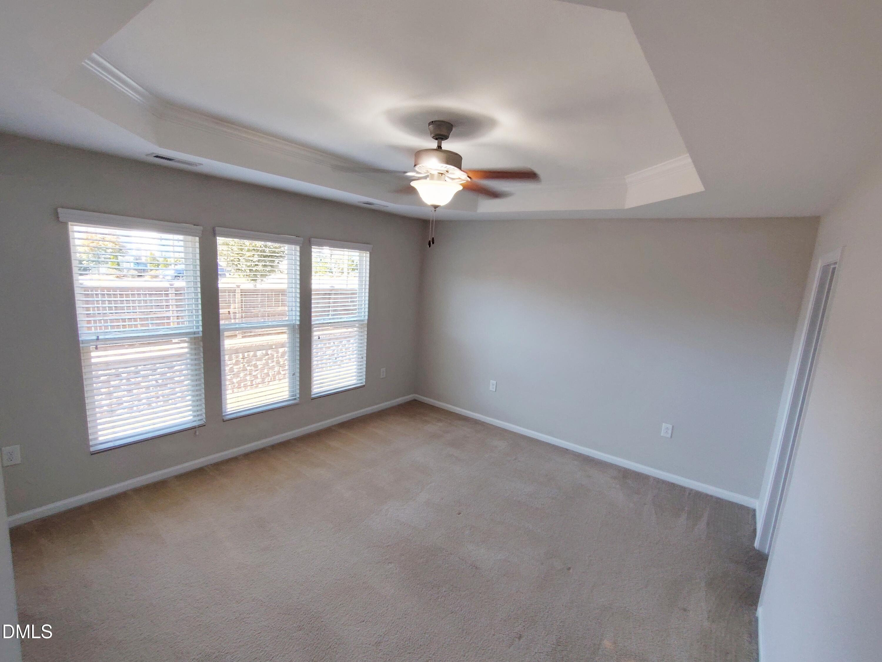 1013 Kudzu Street Durham, NC 27713 - Photo 12 of 21 an empty room with chandelier fan and windows