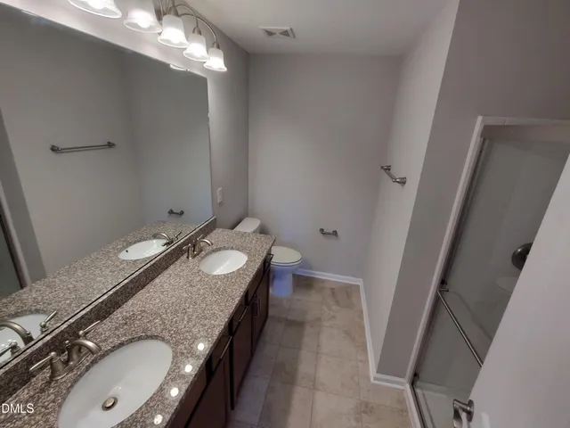 a bathroom with a shower and toilet