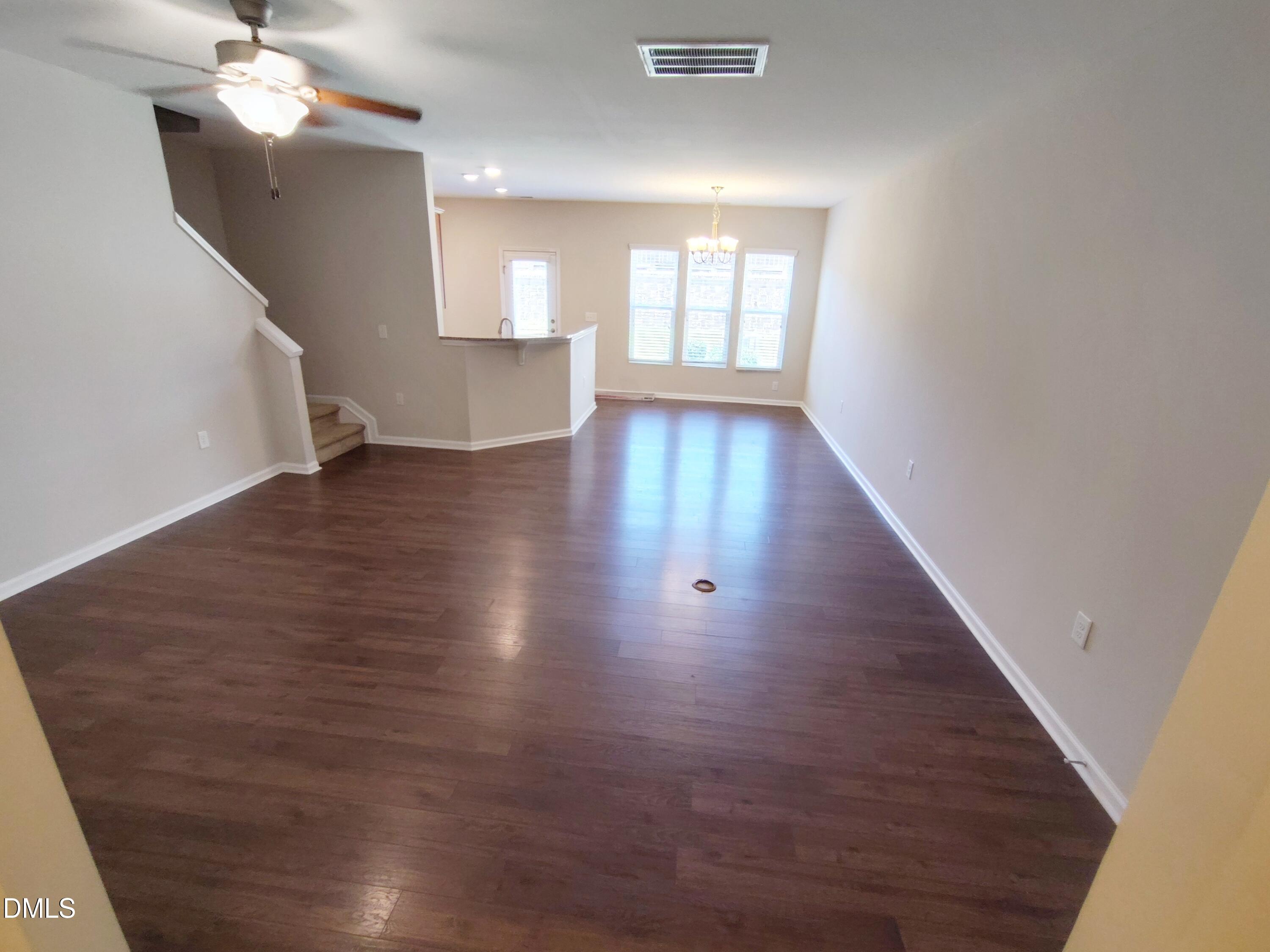 1013 Kudzu Street Durham, NC 27713 - Photo 4 of 21 an empty room with wooden floor and windows