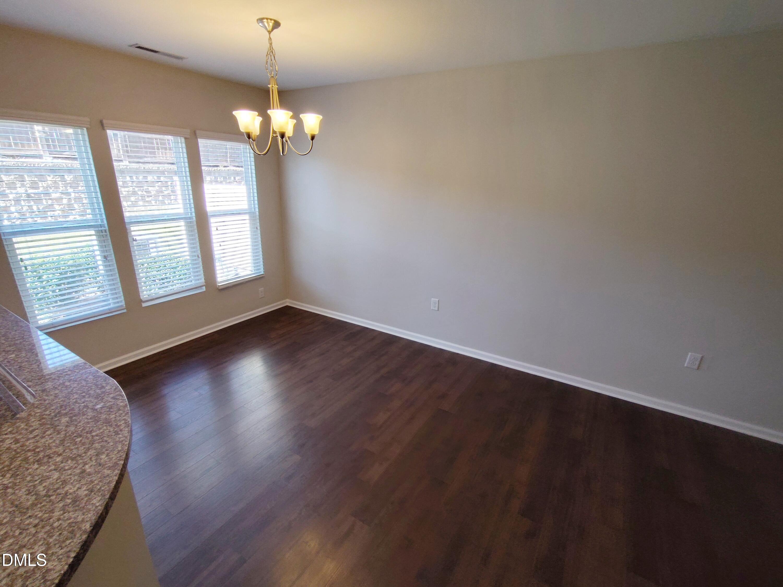 1013 Kudzu Street Durham, NC 27713 - Photo 5 of 21 a view of livingroom with hardwood floor and window