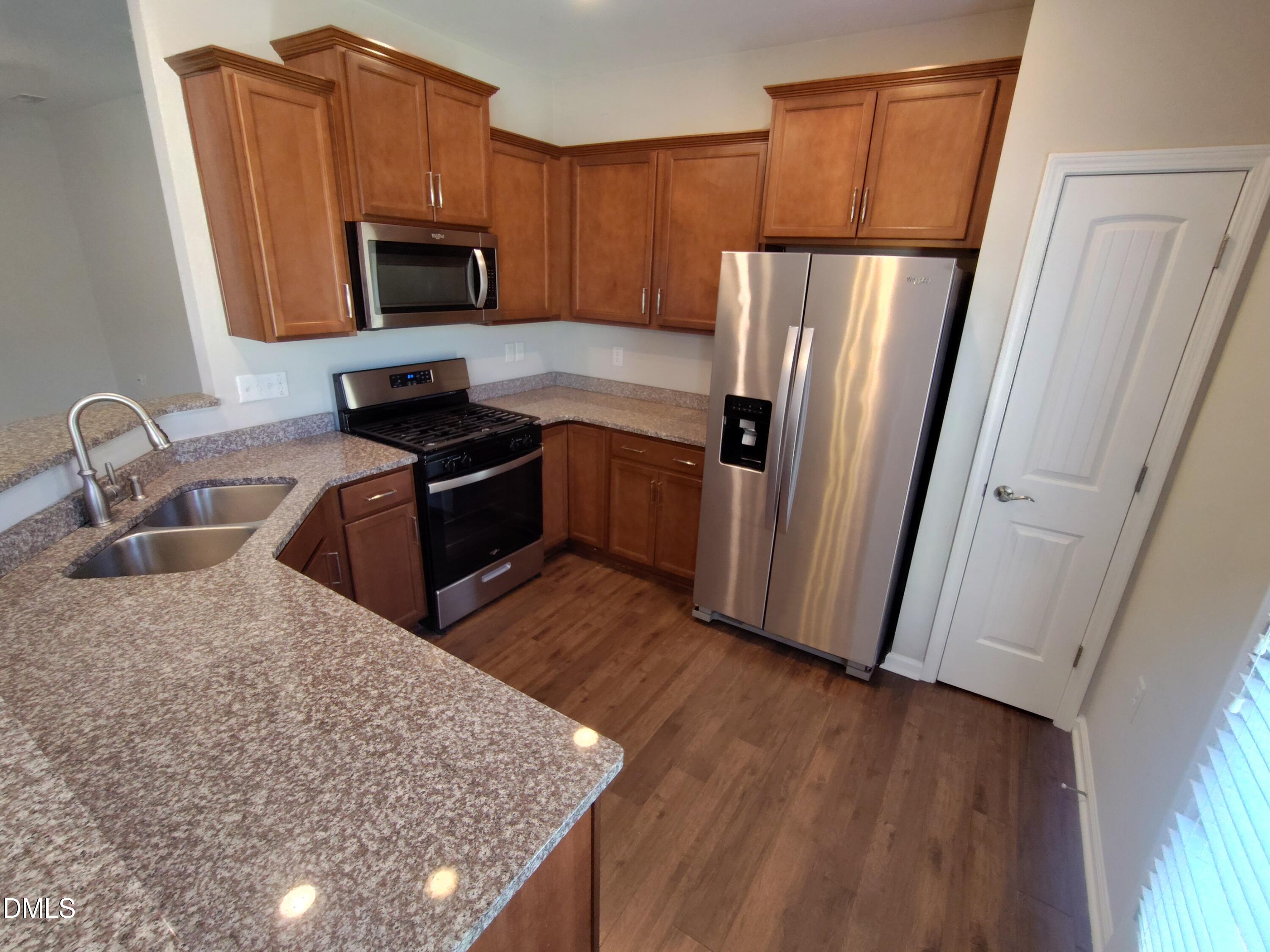 1013 Kudzu Street Durham, NC 27713 - Photo 6 of 21 a kitchen with granite countertop a refrigerator stove and sink