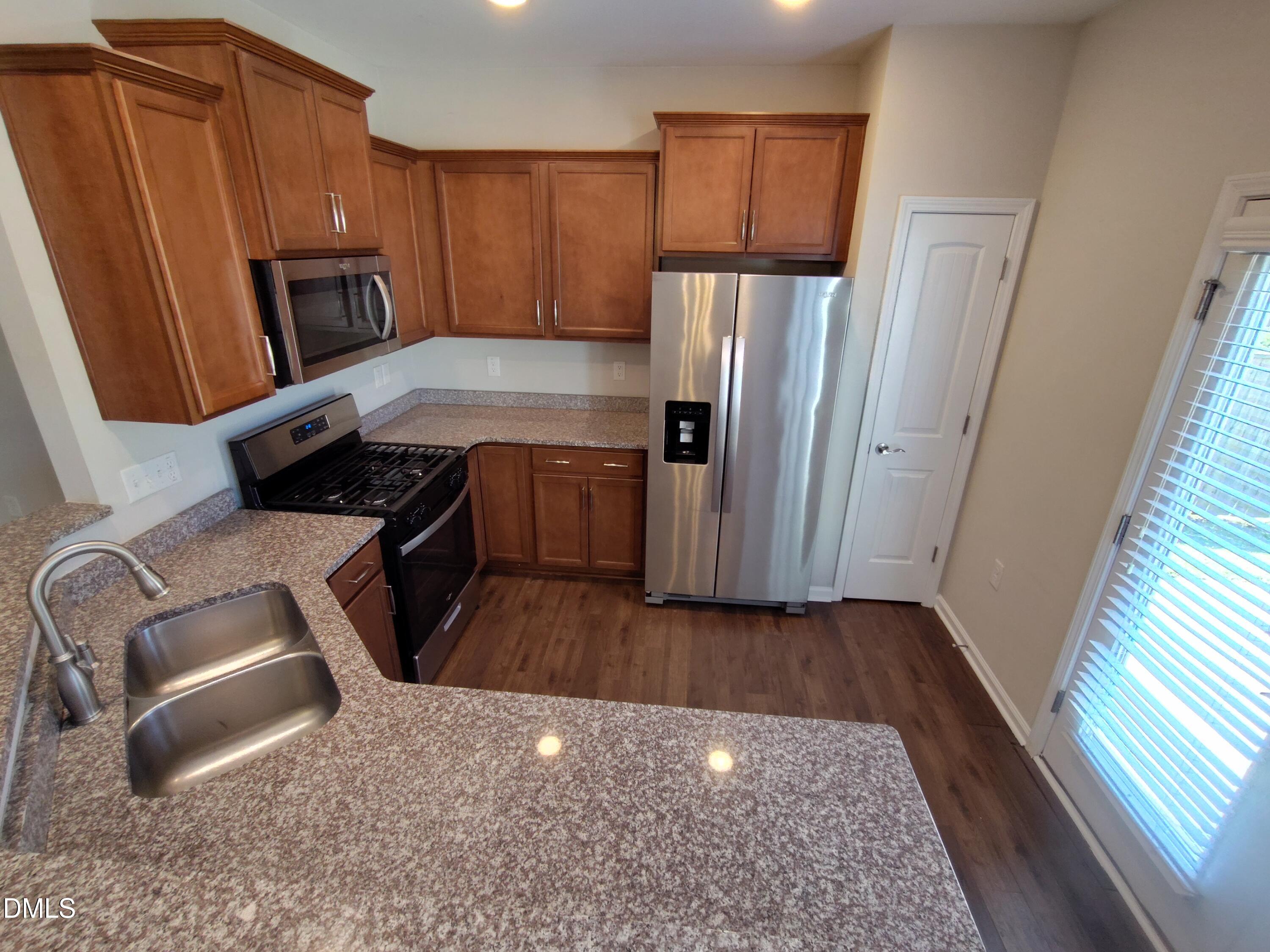 1013 Kudzu Street Durham, NC 27713 - Photo 8 of 21 a kitchen with granite countertop a refrigerator stove and sink