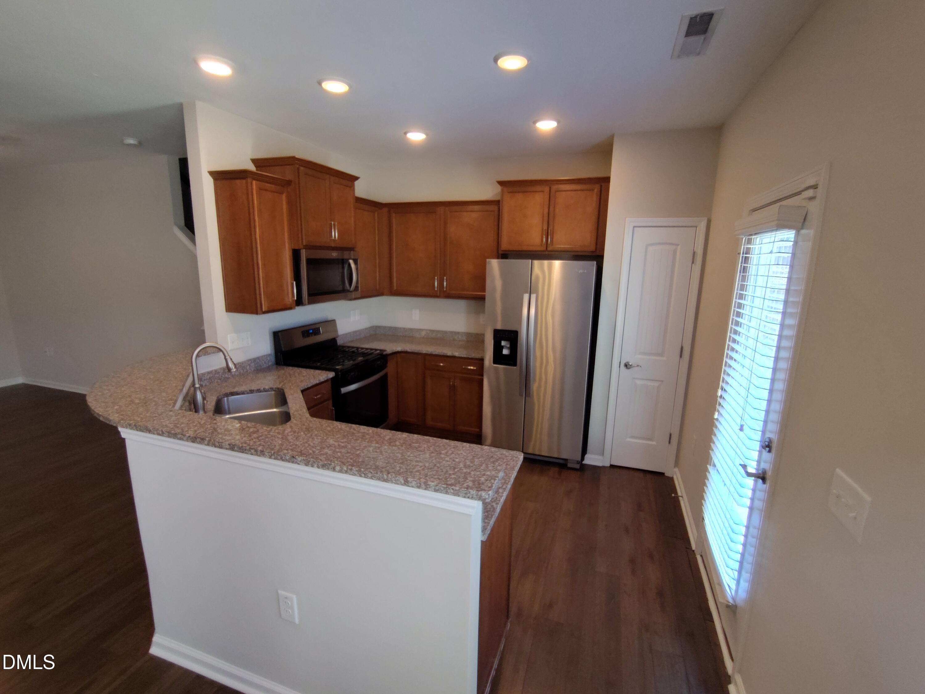 1013 Kudzu Street Durham, NC 27713 - Photo 9 of 21 a kitchen with refrigerator and car