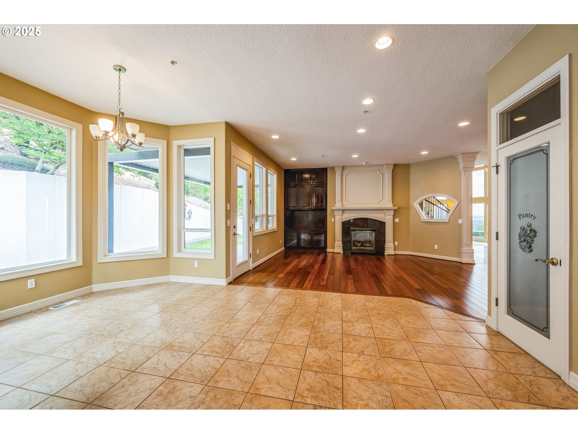 9340 Southeast Emmert View Court Happy Valley, OR 97086 - Photo 27 of 42 a room with a large window and chandelier