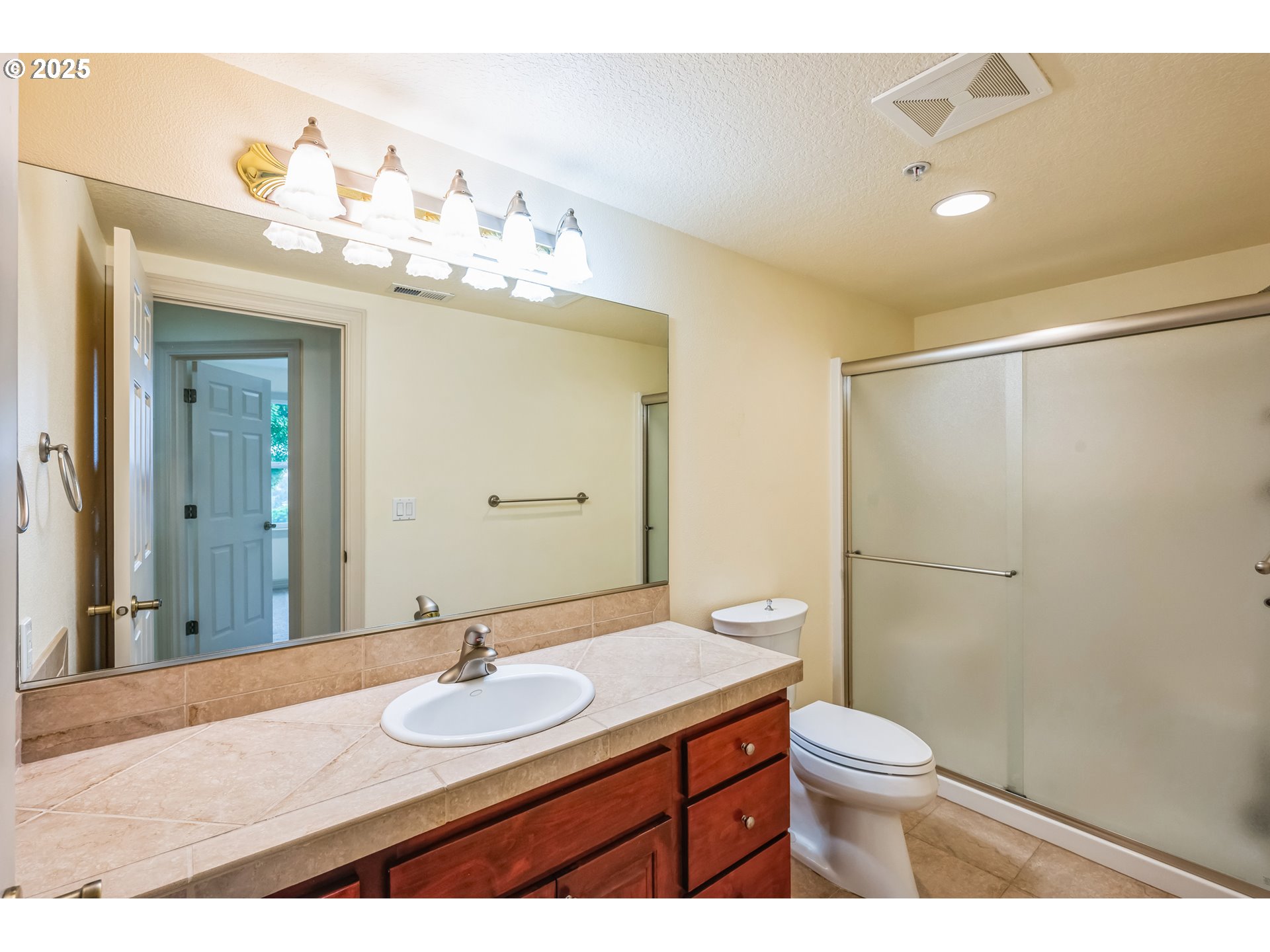 9340 Southeast Emmert View Court Happy Valley, OR 97086 - Photo 37 of 42 a bathroom with a sink vanity mirror and toilet