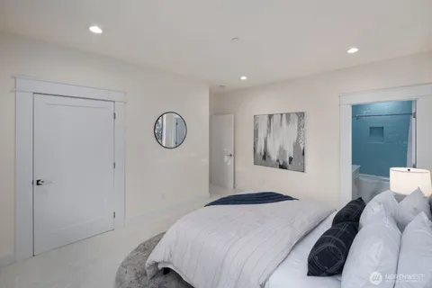 a bedroom with a large bed and a chandelier