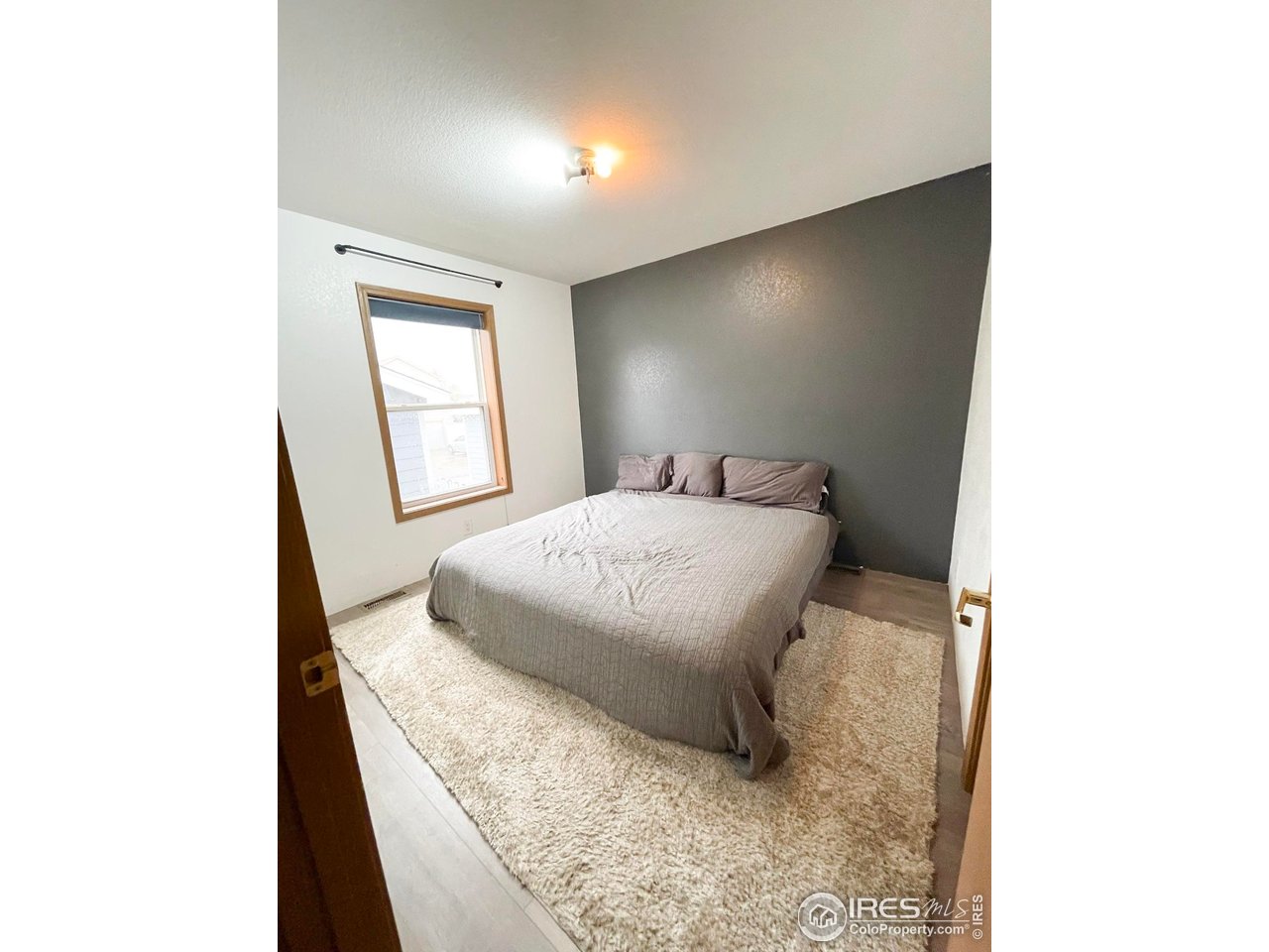 4200 Paintbrush Drive Evans, CO 80620 - Photo 14 of 18 a bedroom with a bed and a window