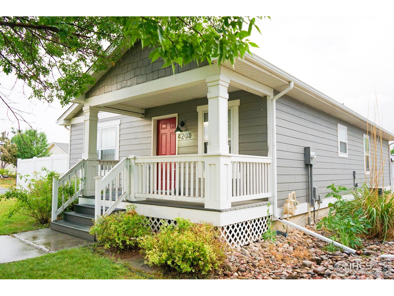 4200 Paintbrush Drive Evans, CO 80620 - Photo 3 of 18 a front view of a house with a garden