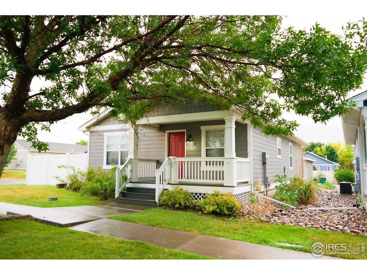 4200 Paintbrush Drive Evans, CO 80620 - Photo 4 of 18 a front view of a house with a yard