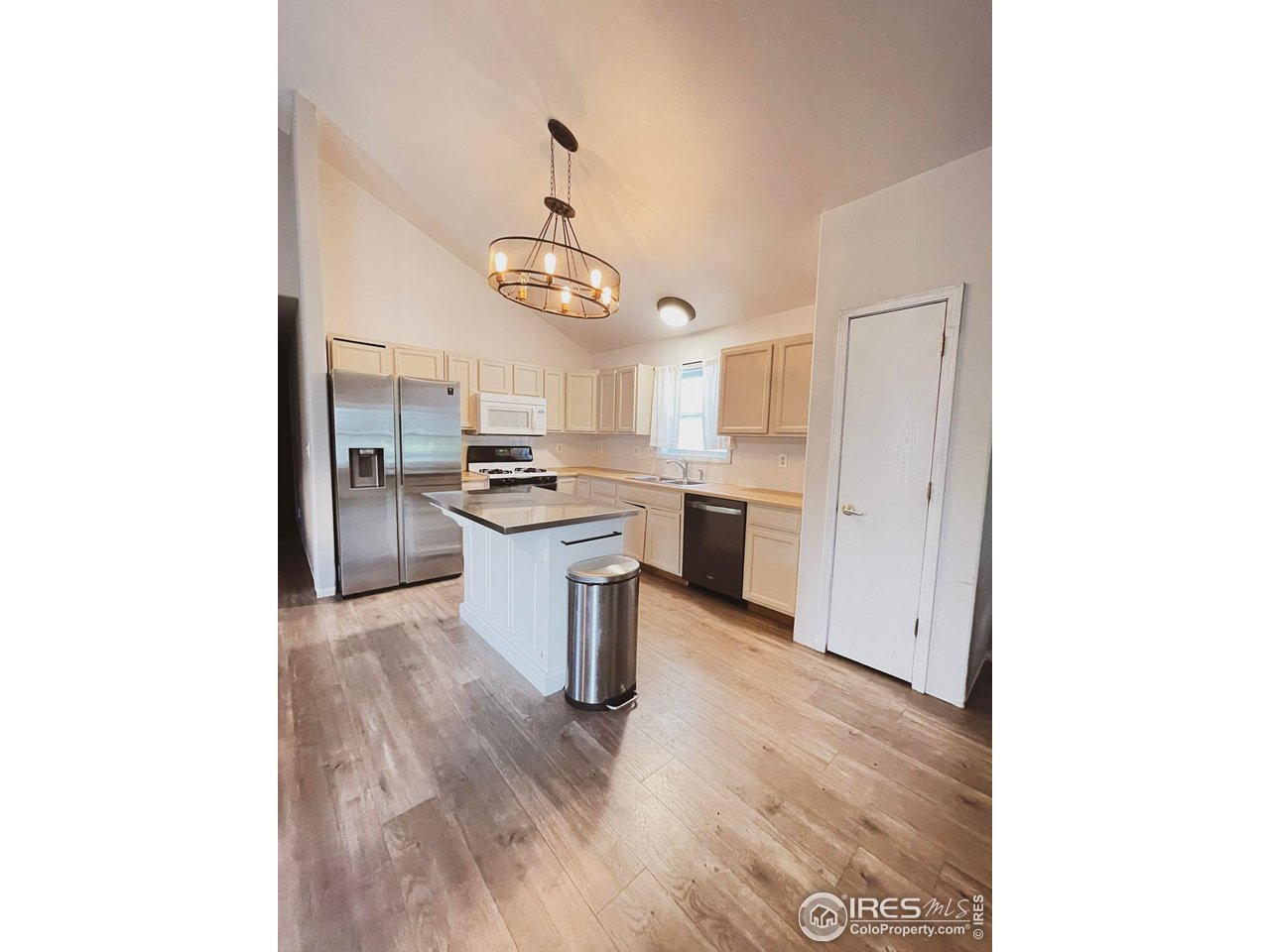 4200 Paintbrush Drive Evans, CO 80620 - Photo 7 of 18 a kitchen with a refrigerator and a sink