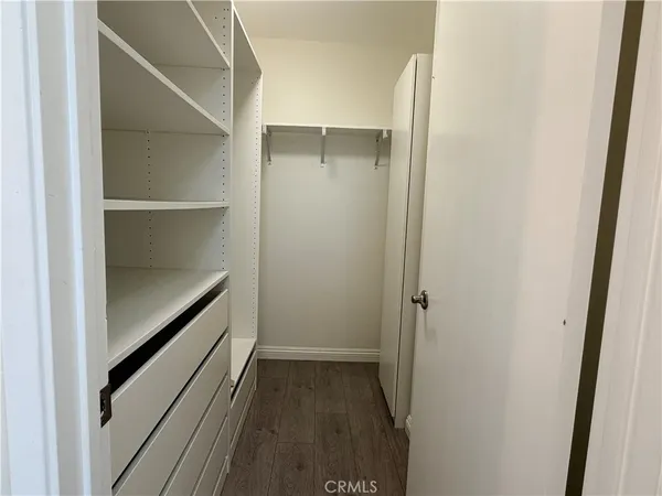 a hallway with closet and wooden floor