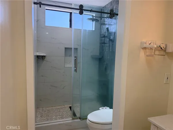 a bathroom with a shower and a toilet