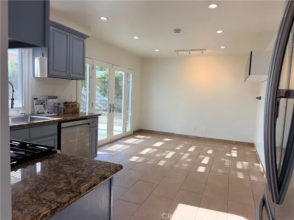 a kitchen with stainless steel appliances granite countertop a sink stove and cabinets
