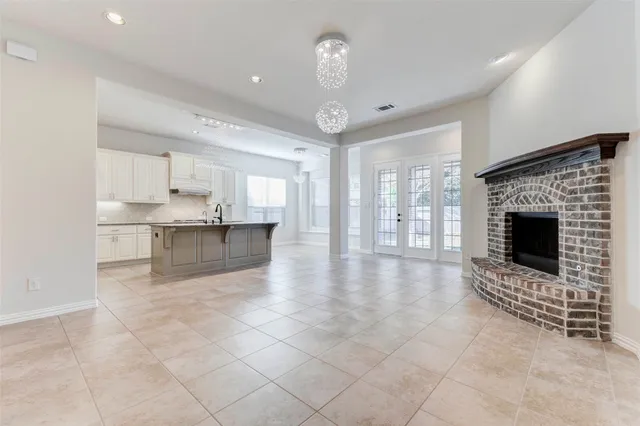 a view of an empty room with a fireplace and a window