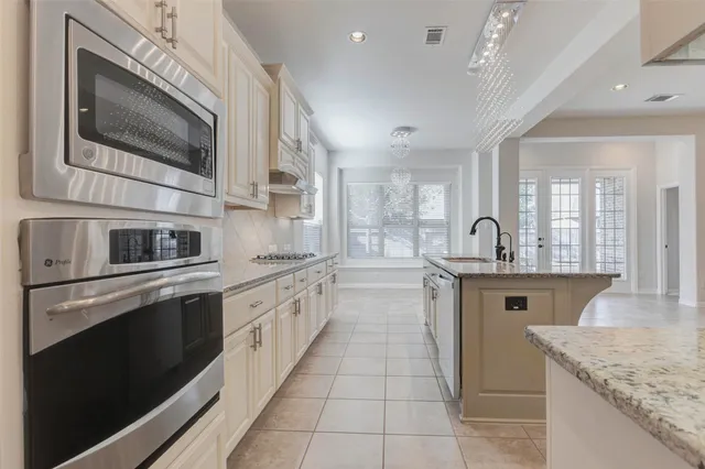 a kitchen with stainless steel appliances granite countertop a sink and a microwave