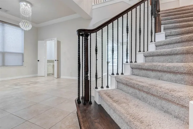 a view of staircase with white walls and a window