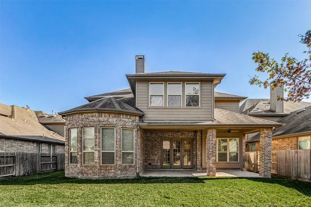 front view of a house with a tree
