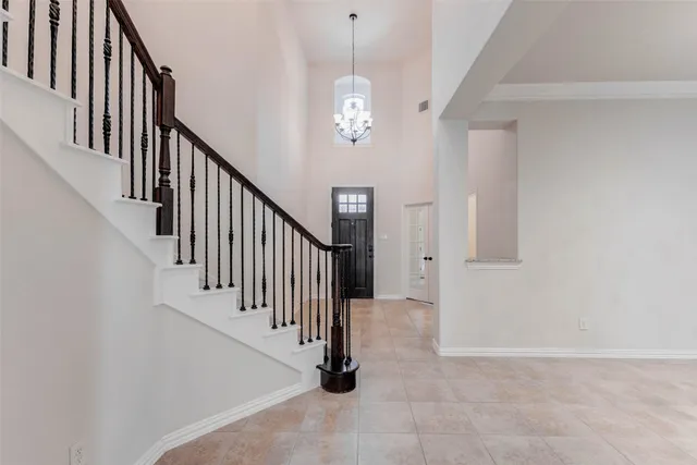 a view of staircase with lots of frames on wall and stairs