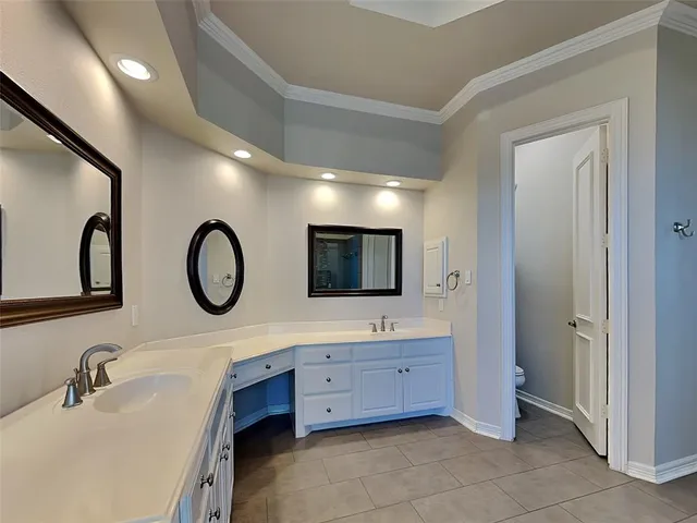 a bathroom with a double vanity sink and a large mirror