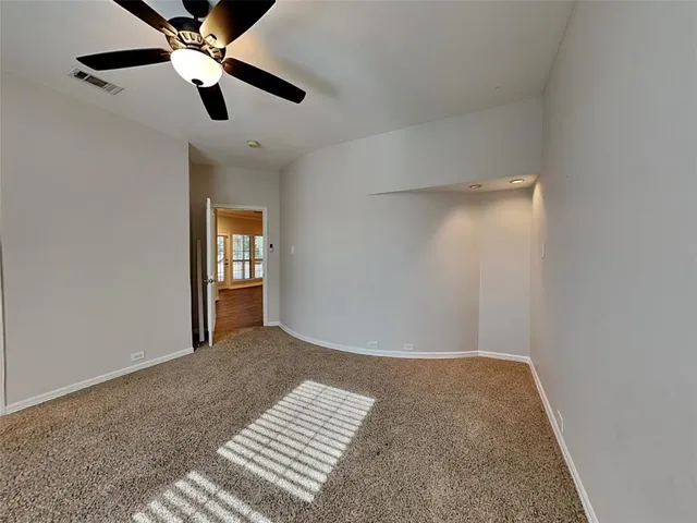 an empty room with closet and windows