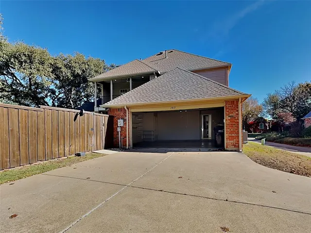 a front view of a house with a garage and a yard