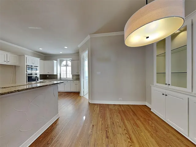a view of a kitchen with wooden floor and a sink