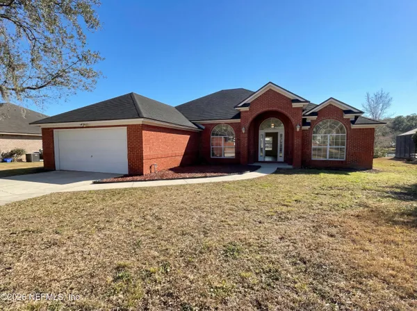 a front view of a house with a yard and garage