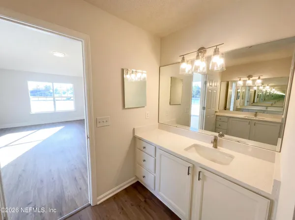 a bathroom with a sink double vanity and a mirror