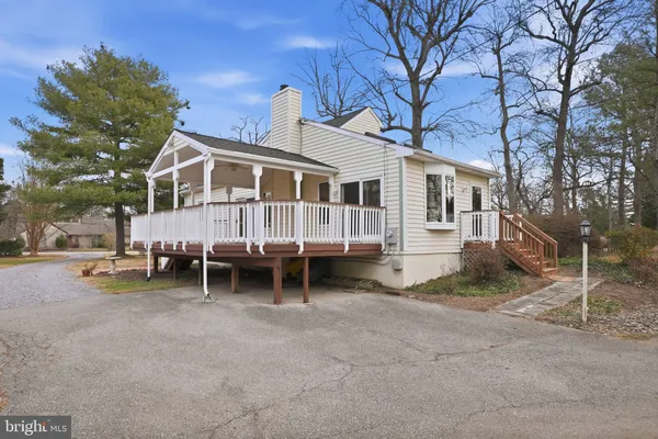 a view of a house with a yard and sitting area
