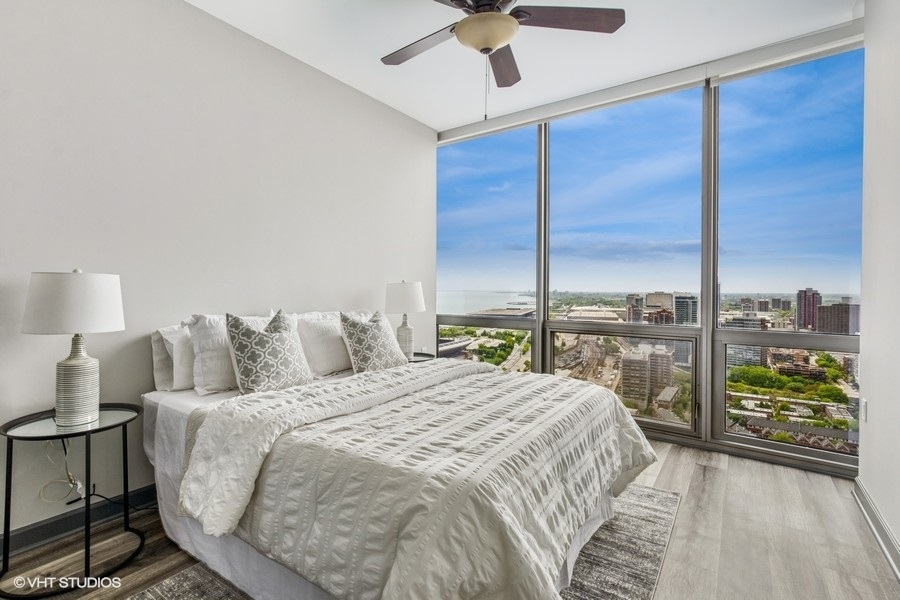 1235 South Prairie Avenue, Unit 3605 Chicago, IL 60605 - Photo 19 of 34 a bedroom with a large bed and a night stand