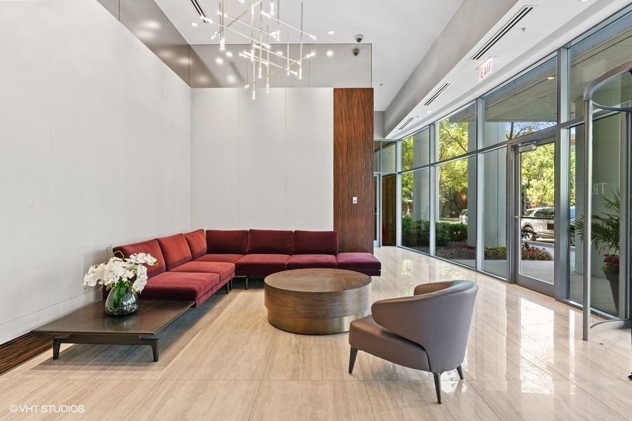 1235 South Prairie Avenue, Unit 3605 Chicago, IL 60605 - Photo 2 of 34 a living room with furniture chandelier and a large window