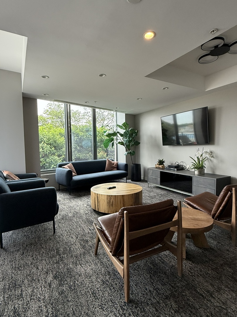 1235 South Prairie Avenue, Unit 3605 Chicago, IL 60605 - Photo 31 of 34 a living room with furniture a flat screen tv and a large window