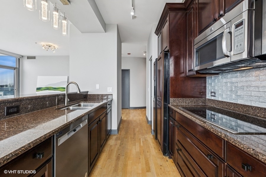 1235 South Prairie Avenue, Unit 3605 Chicago, IL 60605 - Photo 9 of 34 a kitchen with stainless steel appliances granite countertop a sink and a stove