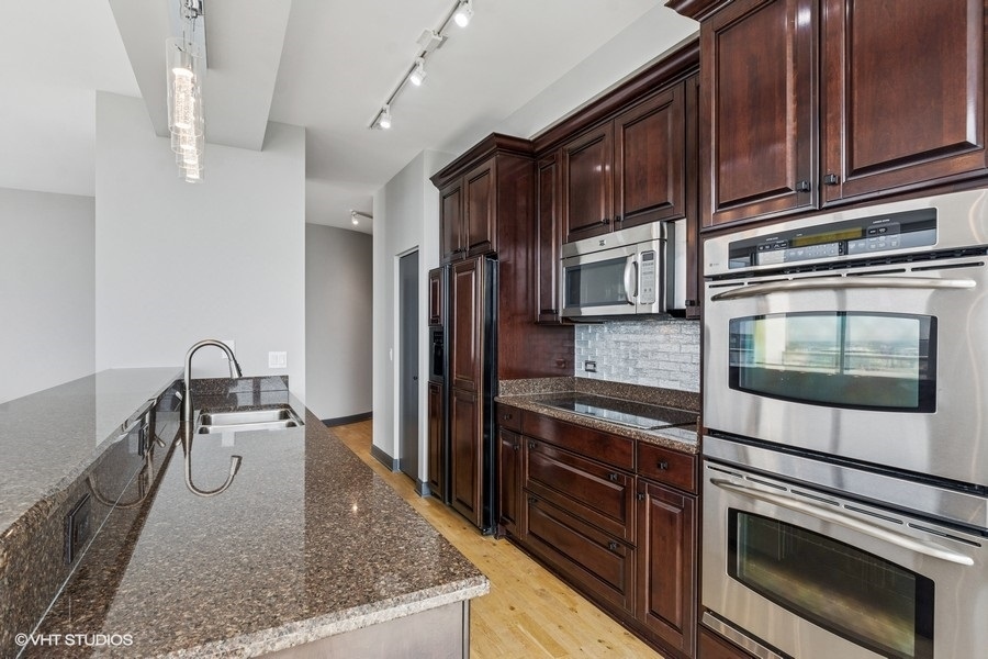 1235 South Prairie Avenue, Unit 3605 Chicago, IL 60605 - Photo 10 of 34 a kitchen with stainless steel appliances granite countertop a stove microwave and refrigerator