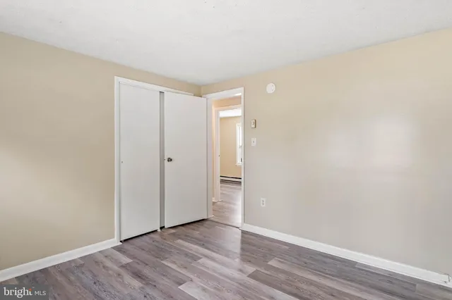 a view of an empty room and wooden floor