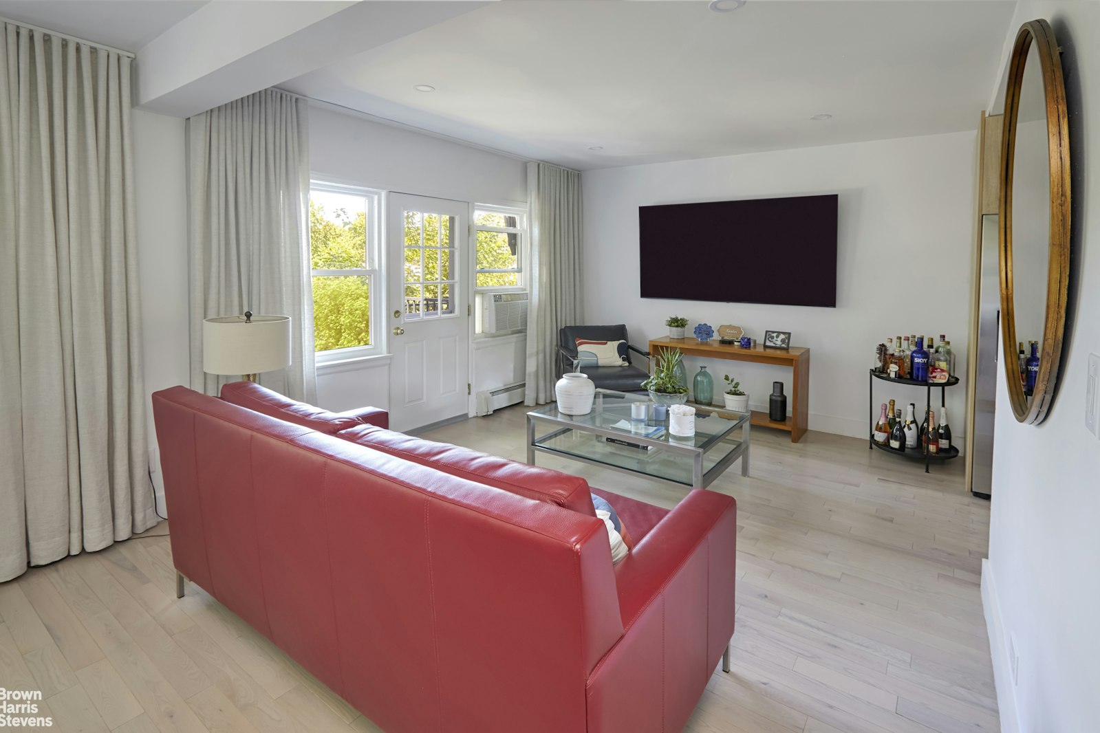 4601 Henry Hudson Parkway West, Unit A7 Bronx, NY 10471 - Photo 12 of 24 a living room with furniture a flat screen tv and a window