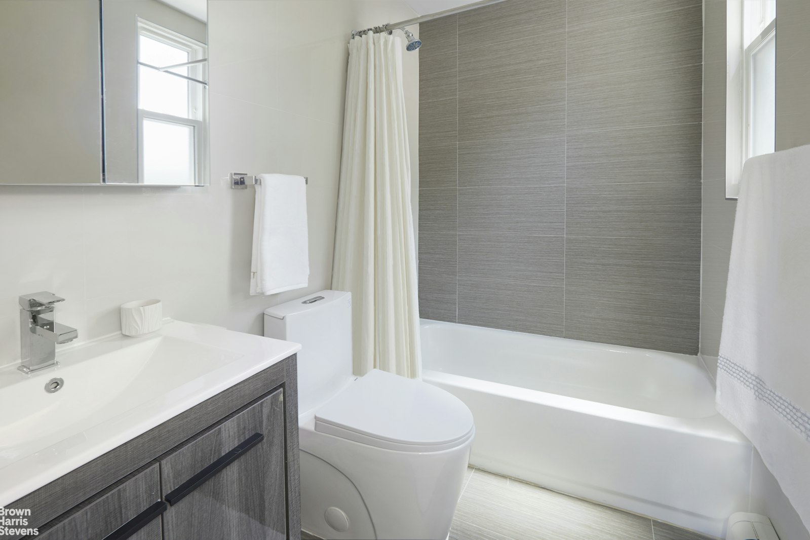 4601 Henry Hudson Parkway West, Unit A7 Bronx, NY 10471 - Photo 23 of 24 a bathroom with a sink toilet vanity and shower