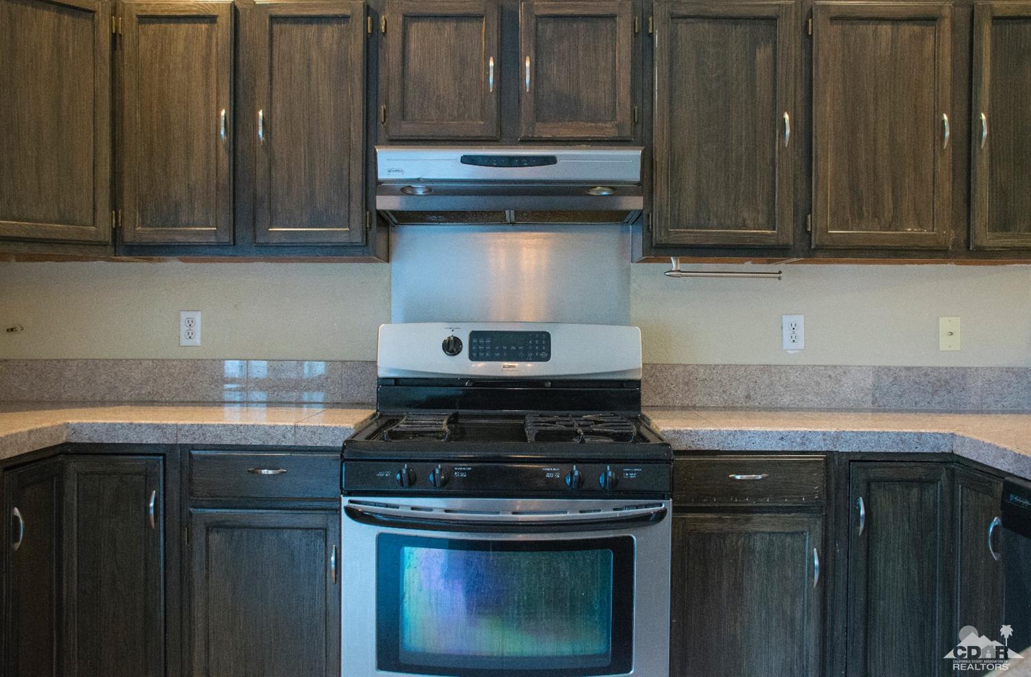 68340 Tortuga Road Cathedral City, CA 92234 - Photo 11 of 37 a stove top oven sitting inside of a kitchen
