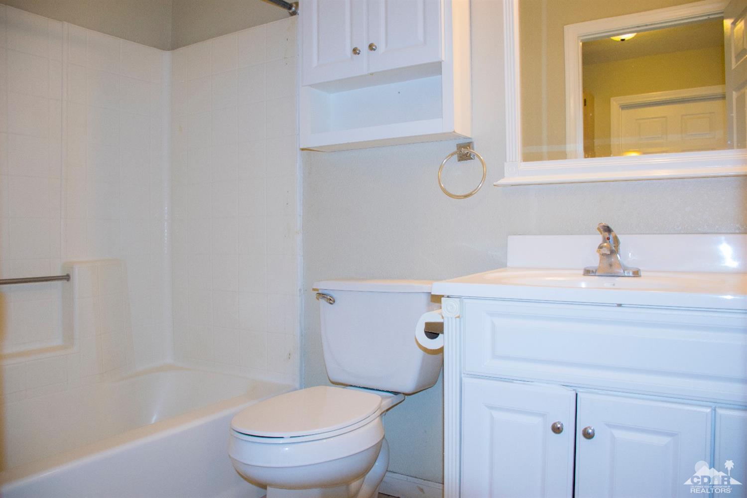 68340 Tortuga Road Cathedral City, CA 92234 - Photo 19 of 37 a bathroom with a sink a toilet and vanity