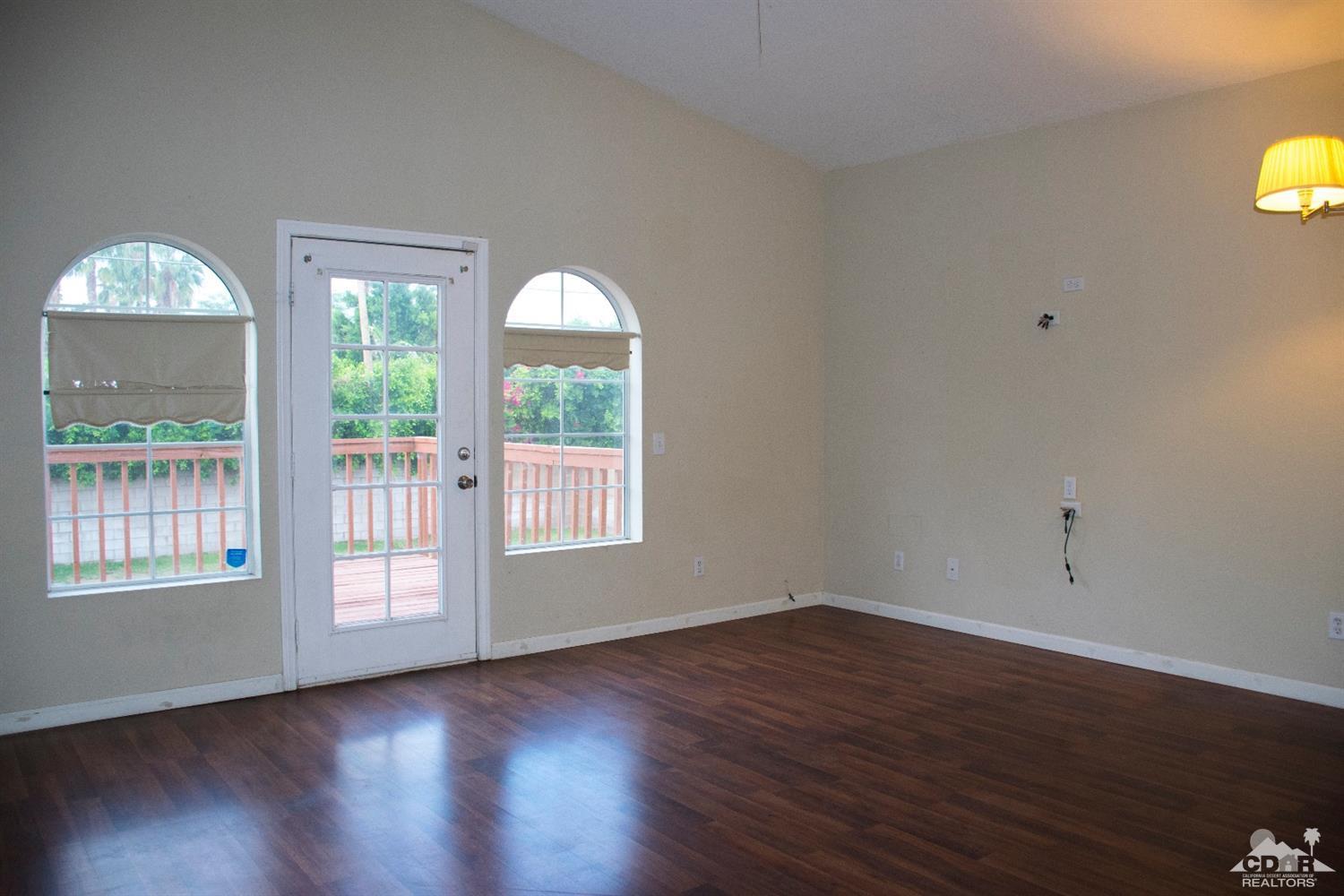 68340 Tortuga Road Cathedral City, CA 92234 - Photo 23 of 37 a view of an empty room with wooden floor and a window